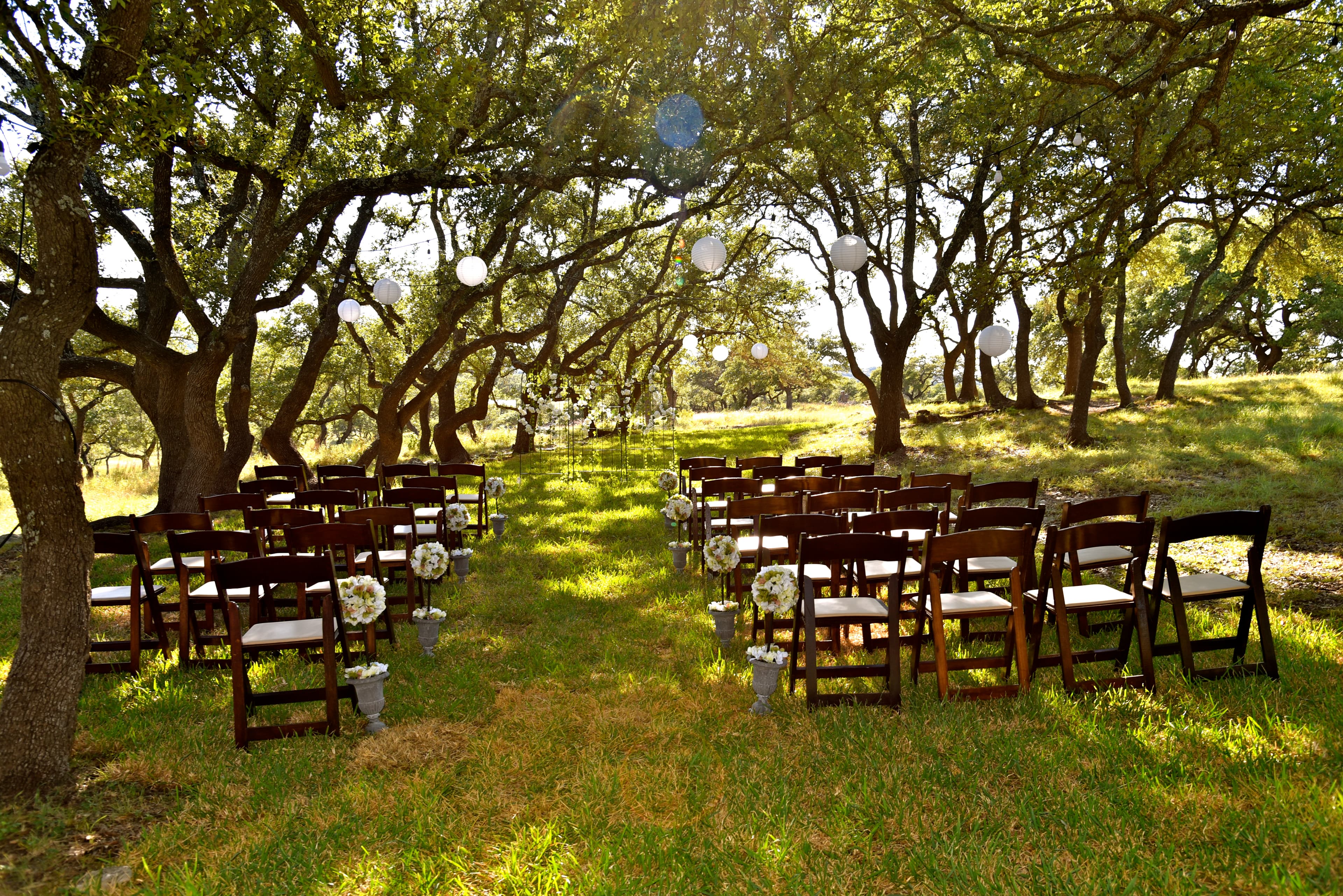 Ceremony chairs set beneath the live oaks for an intimate wedding at The Ranch at Bell Springs